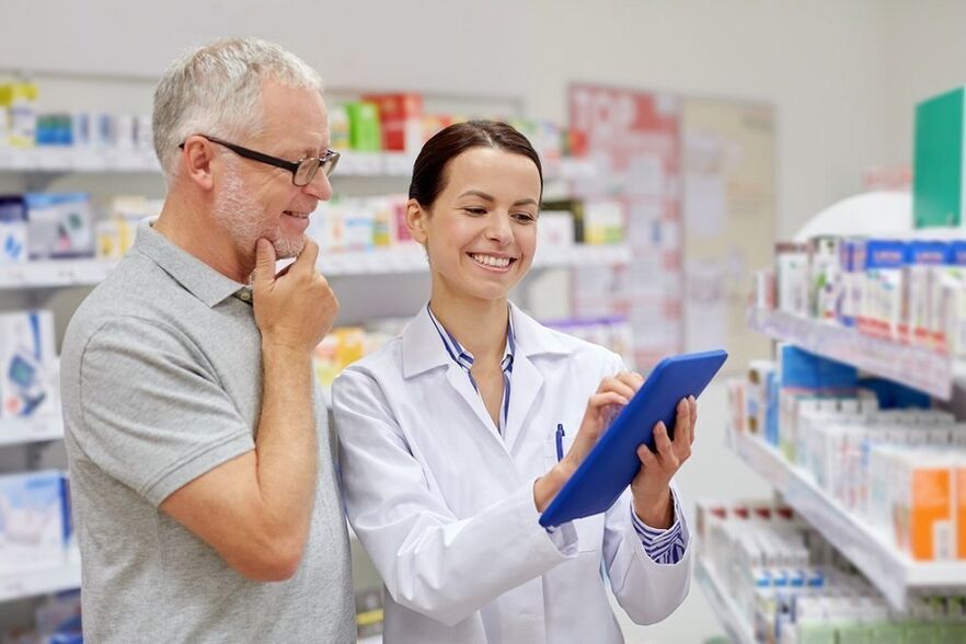 The doctor prescribes medicine for parasites to a man
